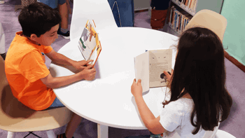 Two kids reading books